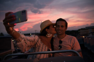 couple taking a selfie atop our gettysburg double decker tour bus at sunset